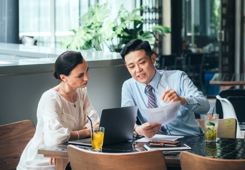 A man and a woman reviewing a form at a desk